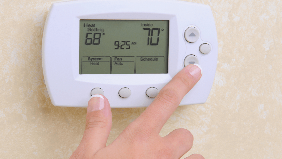 Person operating a thermostat