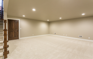 Comfortable basement living space remodel with high-quality carpeting and integrated lighting.